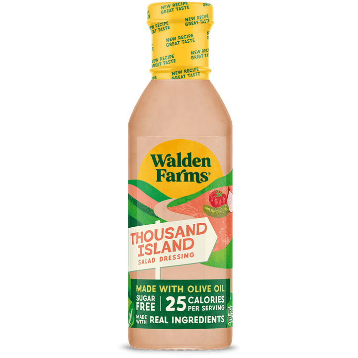 A bottle of Walden Farms Thousand Island Salad Dressing on a solid black background. The bottle contains a peach-colored dressing and features a yellow cap with a green and yellow label.