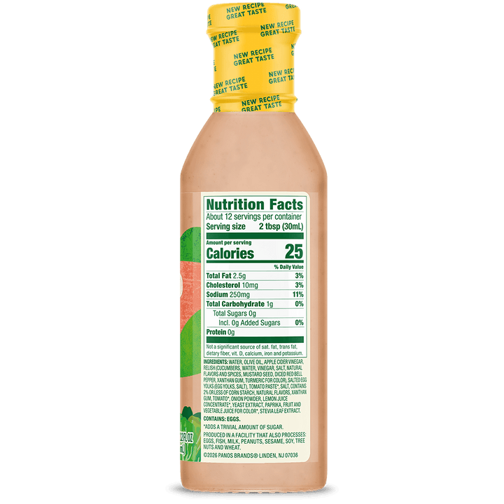 A bottle of Ranch Dress dressing shown from the back, displaying the nutrition facts label, with a yellow cap and light peach-colored liquid inside, set against a solid black background.