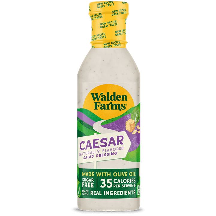 A bottle of Walden Farms Caesar Naturally Flavored Salad Dressing on a solid black background. The bottle is white with a yellow cap and a colorful label featuring green, purple, and yellow graphics.