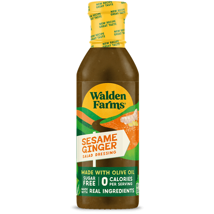 A bottle of Walden Farms Sesame Ginger Salad Dressing on a solid black background. The bottle is filled with a golden-brown dressing and features a yellow cap with a green and white label.